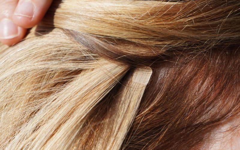 Follow a proper way to apply tape hair extensions