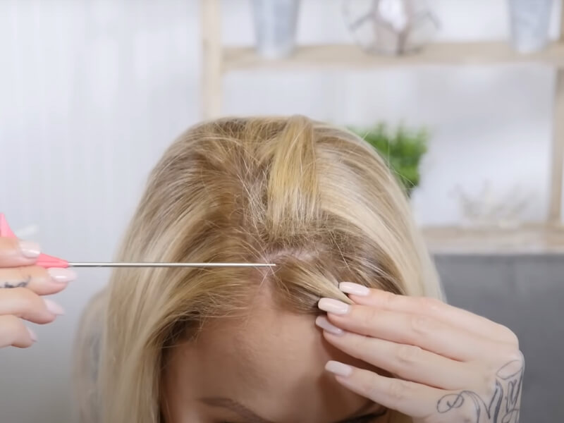 Lightly tease the sections of hair where the clips will attach