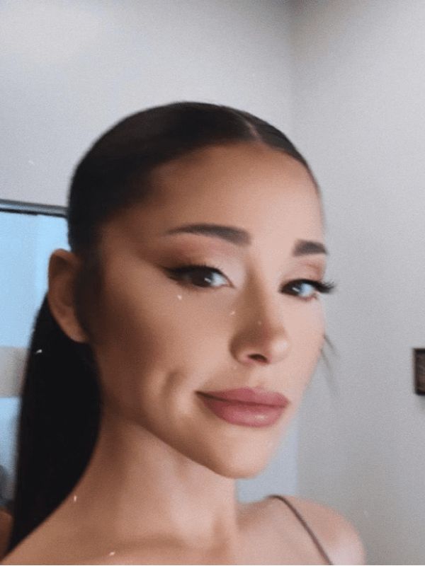 Ariana opts for a classic center-parted ponytail that emphasizes her features