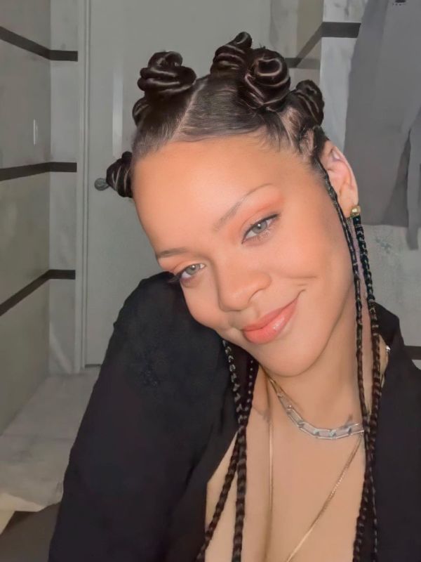 Rihanna pairs a bantu knot look with a half-up, half-down hairstyle