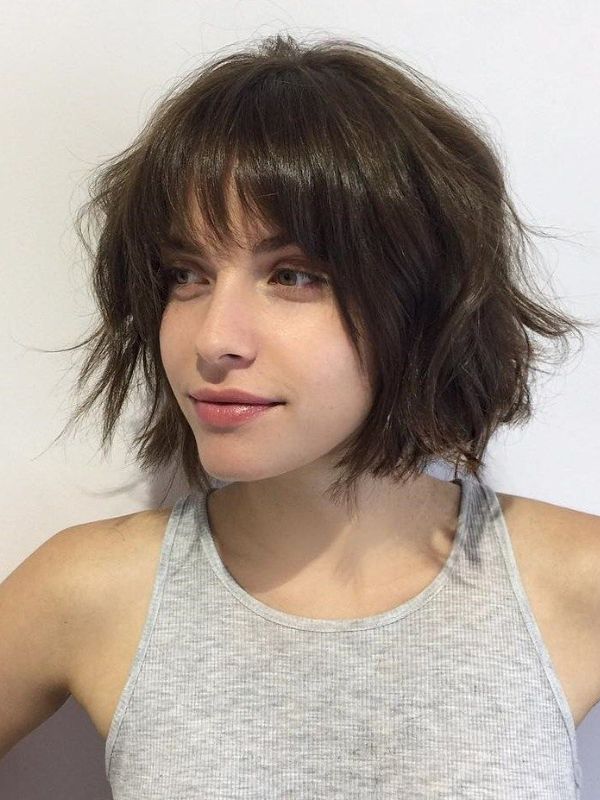 This style features a French bob with bangs haircut that's slightly messy or tousled