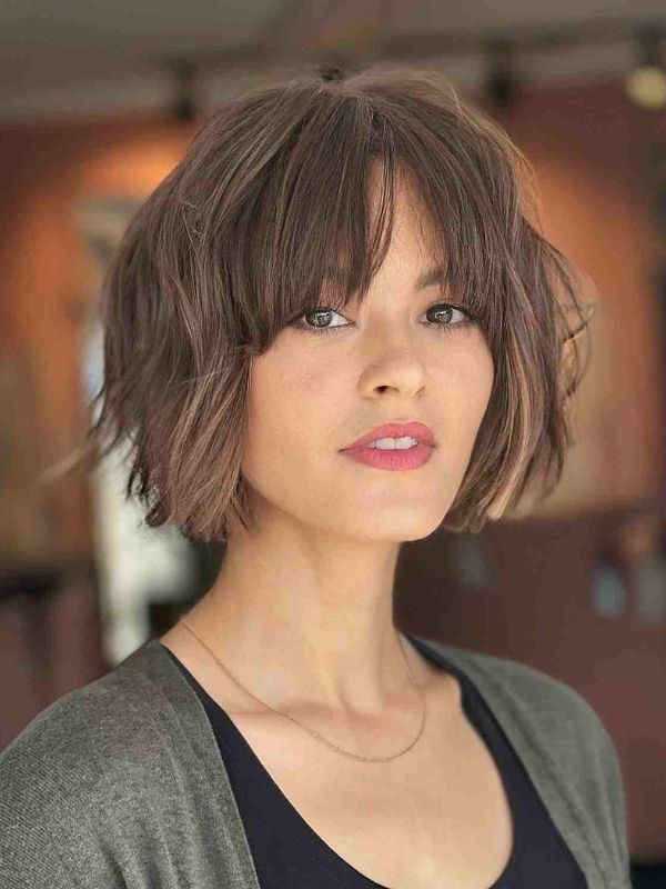 Wispy bangs paired with a chin-length bob create an elegant appearance