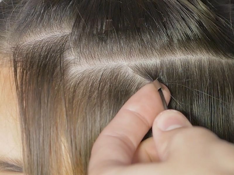 Pull the natural hair strand through a microbead