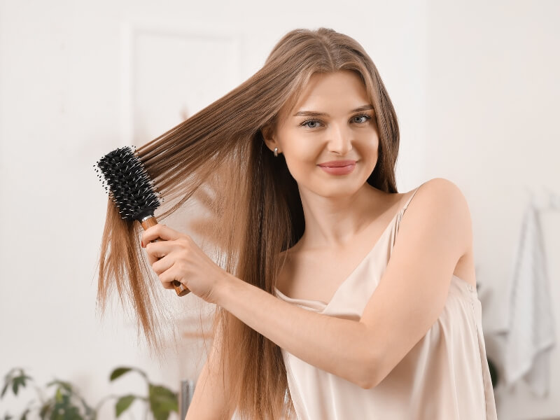 Use a gentle, loop-bristle brush specifically designed for extensions